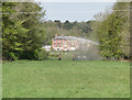 Cockleycley Hall and an irrigator watering the lawns in PE37 8AL