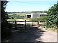 A gate with some farm buildings in CR5 1NA