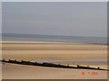 Wooden breaks at Rhyl at low tide in LL18 3AF