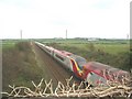 The Holyhead bound Virgin Trains Pendolino at Rhosbadrig bridge in Aberffraw Community