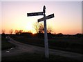 Cast iron signpost by sunset. in CM1 4RD