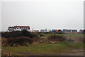 Beach cafe and beach huts, seen from the land side, Hayling Island. in PO11 0AS
