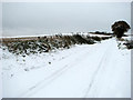 View south along a snowy New Road in NR10 5AU