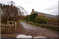 Road leading to Clocksbriggs Farmhouse in DD8 2SA