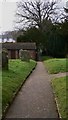 Footpath through churchyard in GU8 4PN