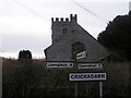 Village church and sign post in LD2 3YU