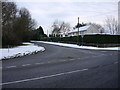 Snowy road junction in CB8 9XF