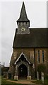 The porch and Spire of St Peter's, Hascombe in GU8 4JA