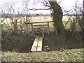 Footbridge and stile on footpath junction in TN27 9BJ