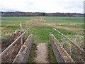 Footpath junction at end of footbridge in TN12 9SX