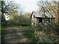 Track and Building in Ravensroost Wood in SN16 9RJ