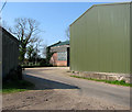 Dereham Lane past agricultural sheds in NR19 2HT