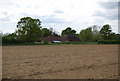 Sayer's Farm across a field from the north in RH13 9GP