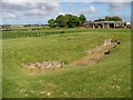 Carlungie Earth House with Carlungie Farm in the background in DD7 7SD