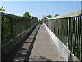 View west across footbridge that links America Wood with Ashington in Ashington (Horsham)