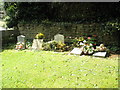 Graves in the churchyard at St John the Evangelist, Milton in OX15 4SX