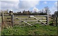 Gate with St John the Baptist church in background in LE7 3RN