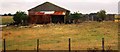 Derelict farm buildings by Camber Rd in TN31 7TL