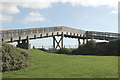 Looking south at a footbridge over the railway east of Penzance in TR18 3RF