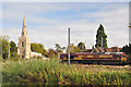 St Peter's church and freight train - Offord D'Arcy in PE19 5WX