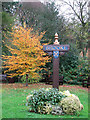 Village sign on the green beside The Street in Brooke