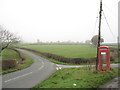 Road junction and phone box on B4382 in SY21 0JY