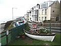 Flower- and pebble-filled boat in a memorial garden, on Criccieth cliff-top in LL52 0ER