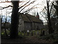 A dull December afternoon in the churchyard at The Assumption, East Wittering in PO20 8JA