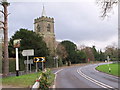 The 'Plough' Inn sign and Holy Trinity church, Lower Beeding, West Sussex in Lower Beeding