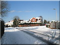 Approaching the junction of a snowy Scratchface Lane and Matthews Close in PO9 1LT