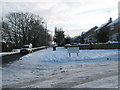 Junction of a snowy Littlepark Avenue and Hulbert Road in PO7 8AA