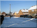 Looking down asnowy Burgate Close towards Hazleholt Drive in PO9 3AA