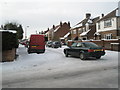 A snowy scene at the junction of Mansvid Avenue and Tregaron Avenue in PO6 2DS