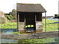Partially submerged bus shelter at Abingworth in Abingworth