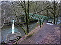 Footbridge and pipe over the River Irwell in BL9 5NS