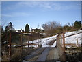 The footbridge adjacent to the site of an old rail bridge in AB34 5QF