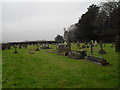 Far end of the churchyard at Holy Cross, Binsted in GU34 4PD
