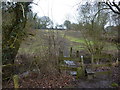 Stile and footbridge, and muddy path ahead in S18 7SD