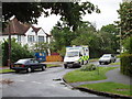Grange Road, Woodham, with ambulance in KT15 3AZ