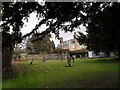 A verdant churchyard at All Hallows, Woolbeding in GU29 9RR