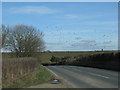 Minor road approaches its junction with the A46 in SN14 8ES