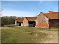 Track past old barns at Wood Farm in South Norfolk District