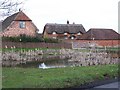 Pond and houses, Hamptworth in SP5 2DR