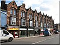 Sidwell Street: terrace of shops with carved brick facade in EX4 6TL