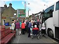 Tourists getting off a coach, Callander in FK17 8BN