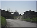 Farm buildings by a bend in the road in Vale of White Horse District