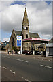 St Pauls Parish Church and Esso filling station at Forth in ML11 8BT