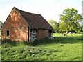 Small brick-and-tile building in a field in B95 5ET
