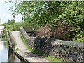 Towpath rising over former canal arm in SK16 4RR