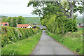 Road, hedge and houses at Spott in EH42 1UU